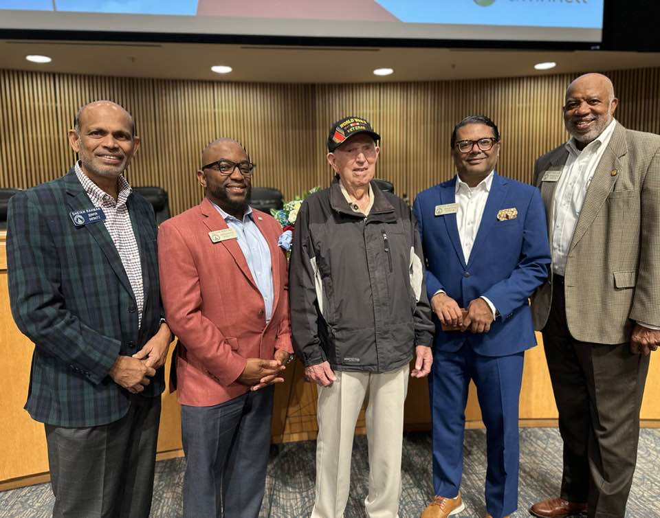 group picture of Representative Sheikh Rahman, Representatie Segun Adeyna, John a World War 2 vet, Representative Farooq Mughal and Representative Dewey McClain